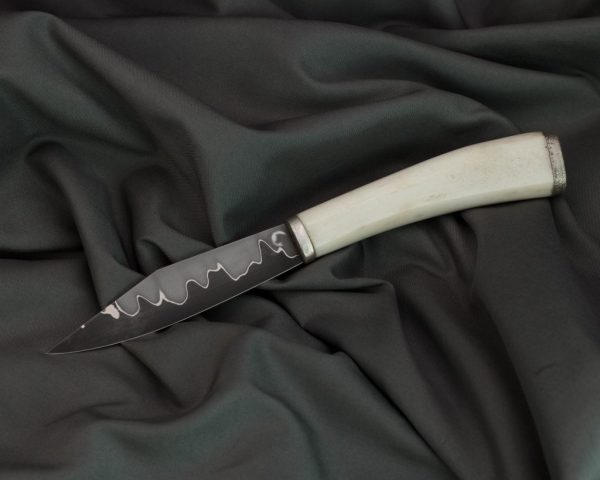 san mai blade with O1 core and mild steel cladding, the blade is ~100mm long and 3mm thick at the back, antler handle with silver fittings, leather sheath